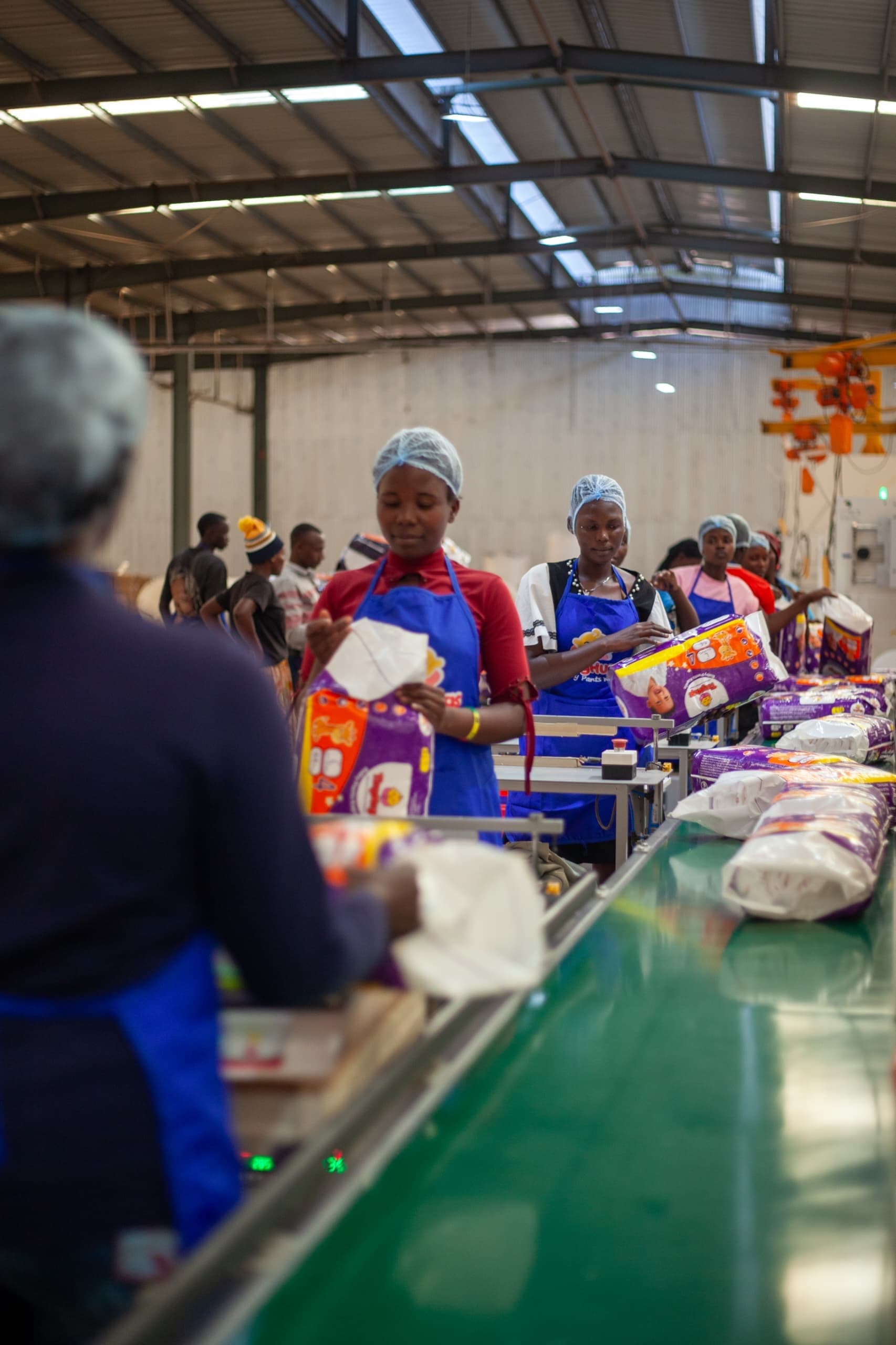 Team members packing finished pants along the line