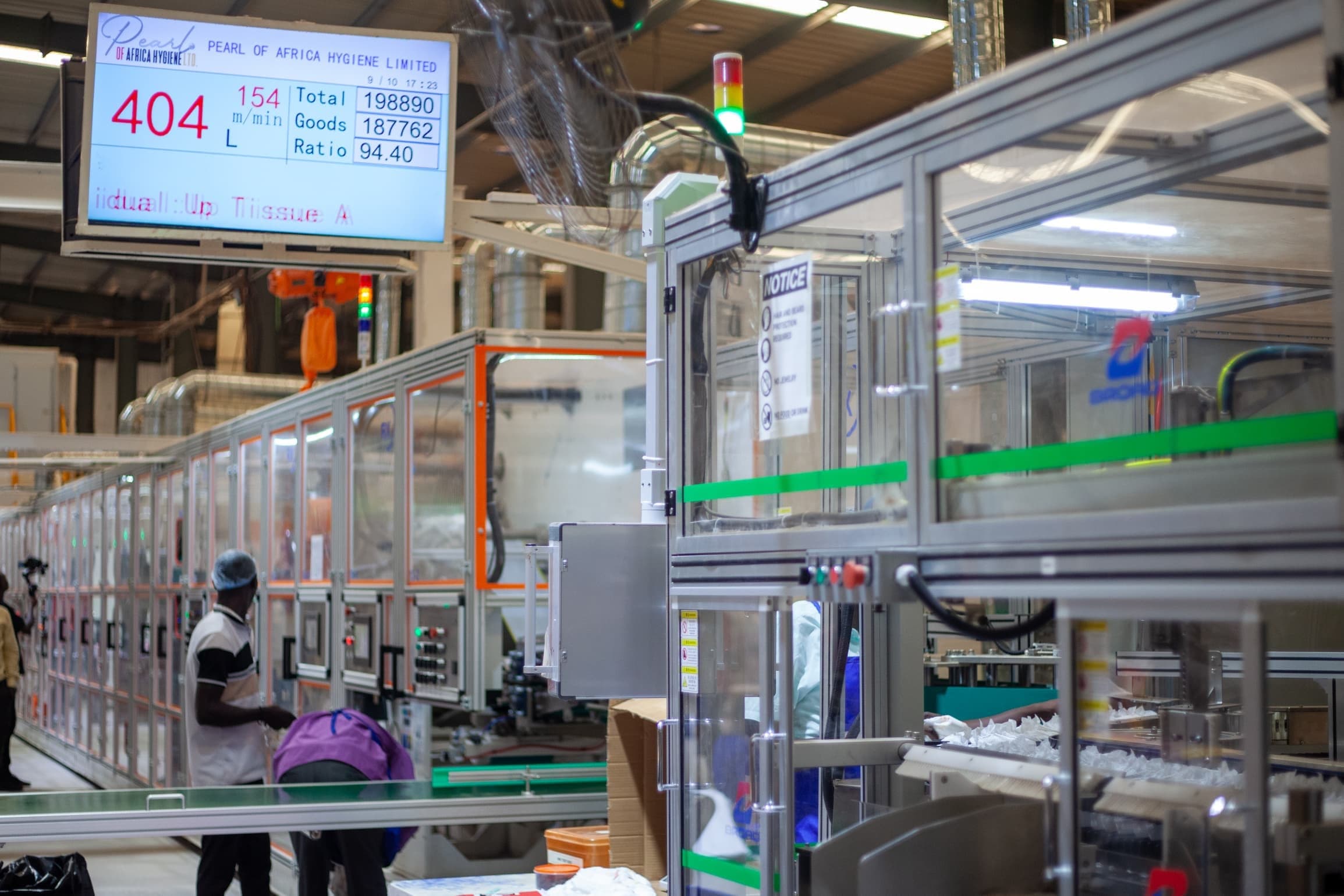 The production line with the output monitor showing line speed and pass rate